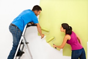 Couple painting home.