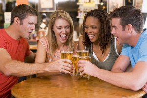 Group of young friends toasting in a bar